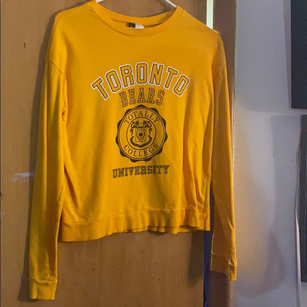 Yellow Toronto sweatshirt.